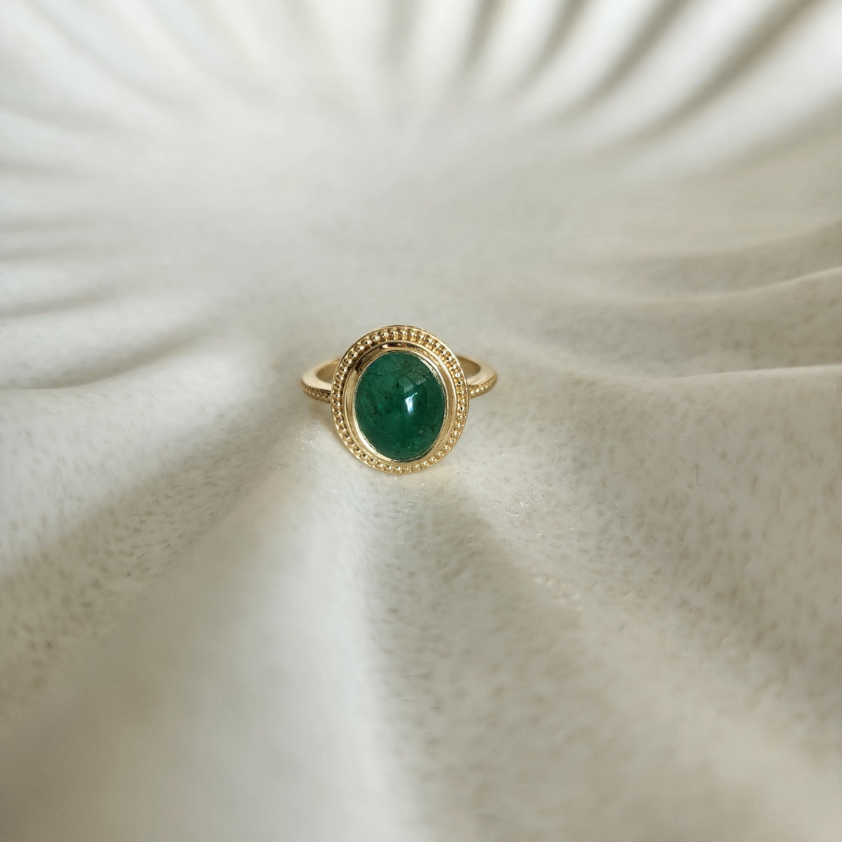 14 Karat Yellow Gold Bezel Set Oval Cabochon Emerald Ring With Milgrain Detail