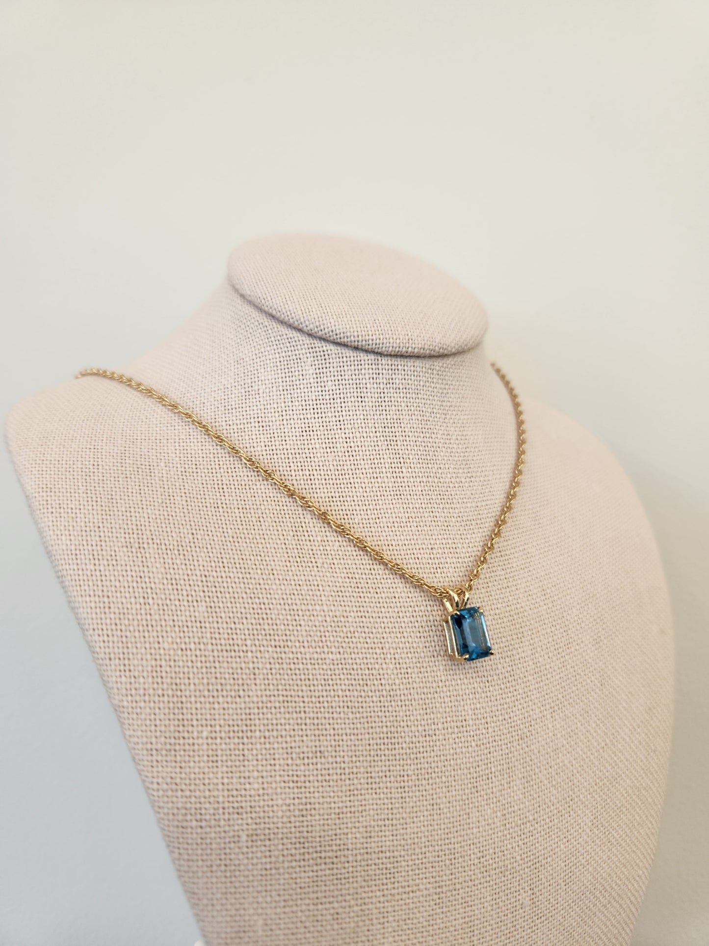 14 Karat Yellow Gold Emerald Cut Blue Topaz Solitaire Pendant