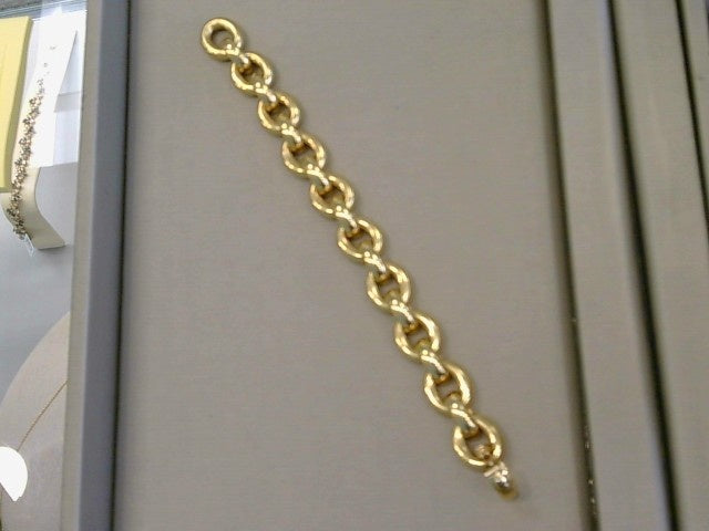 18KYG 7 inch oval fully rounded semi solid links connected by fully rounded half oval links with securing flat back design. Having fold over clasp with safety figure 8 clasp.