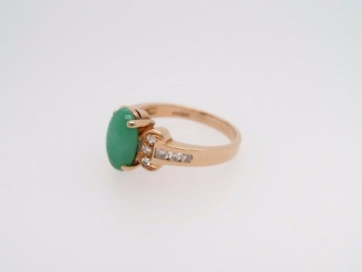 Vintage 14 Karat Yellow Gold Ring Containing An Oval Green Jade At Center Surrounded By Round Brilliant Diamonds