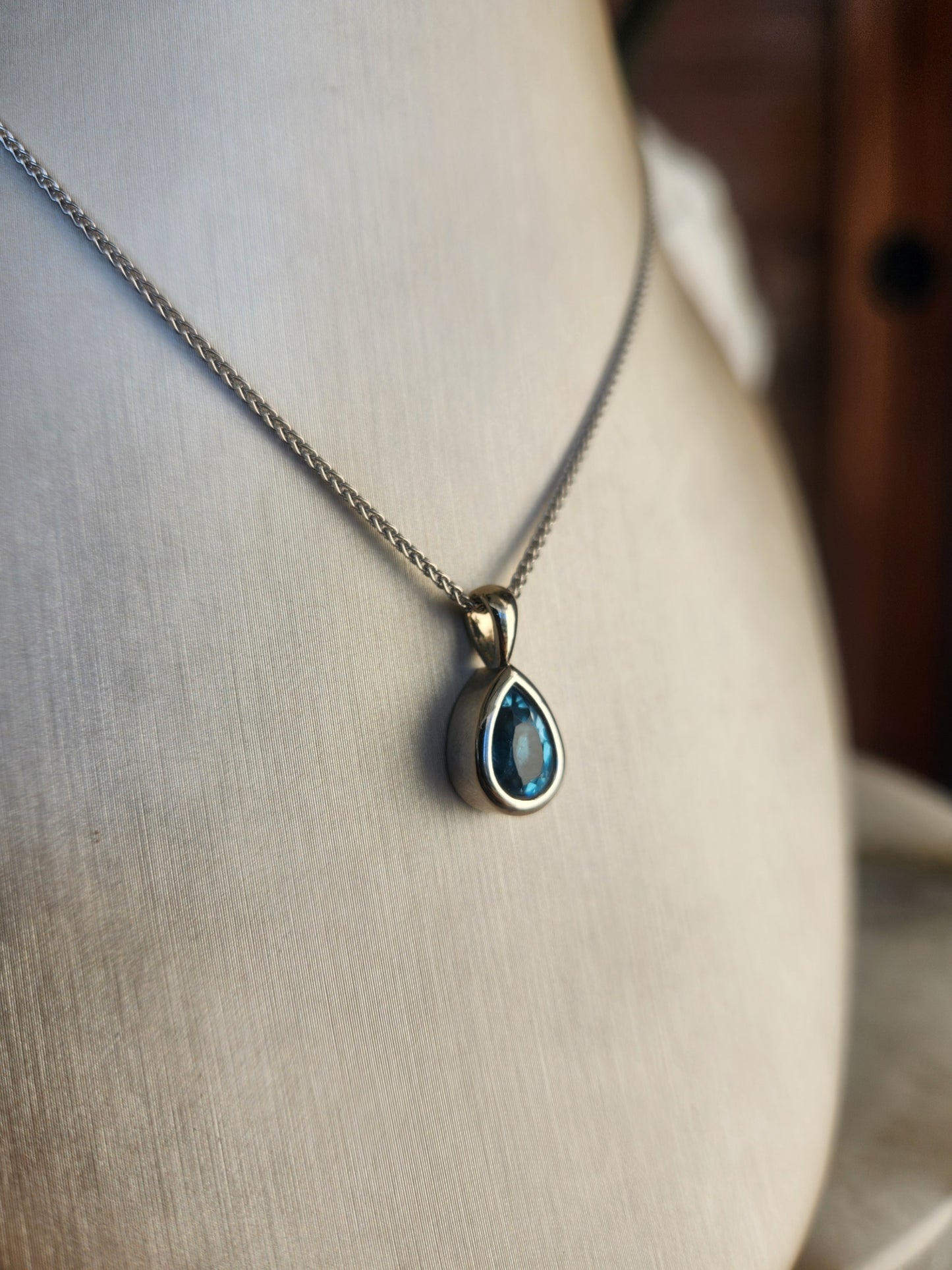 14 Karat White Gold Bezel Set Pear Blue Topaz Solitaire Pendant