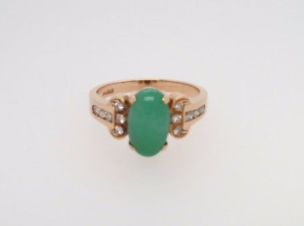 Vintage 14 Karat Yellow Gold Ring Containing An Oval Green Jade At Center Surrounded By Round Brilliant Diamonds