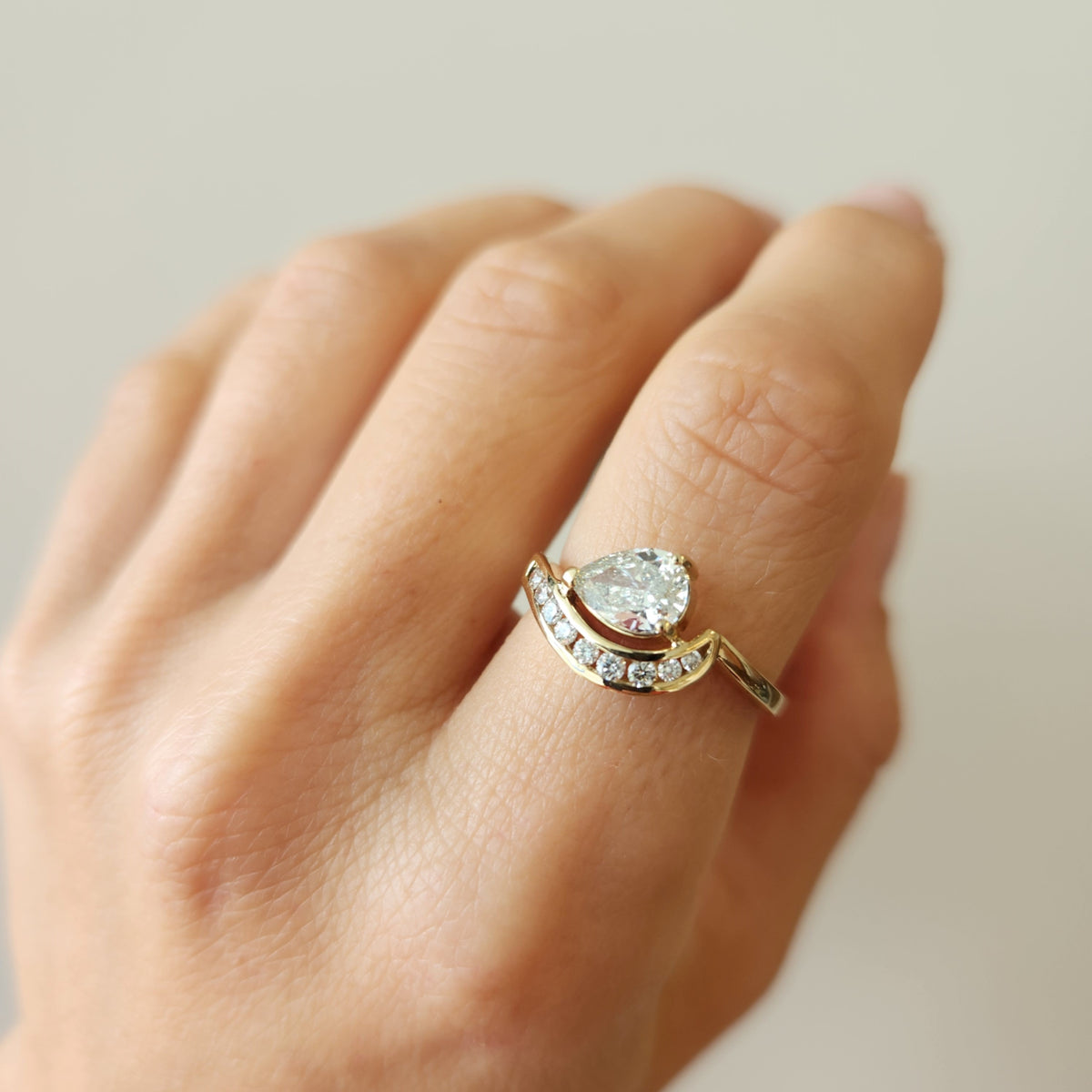 14 Karat Yellow Gold Pear Shaped Diamond "Wave" Design Ring With Channel Set Diamond Accents