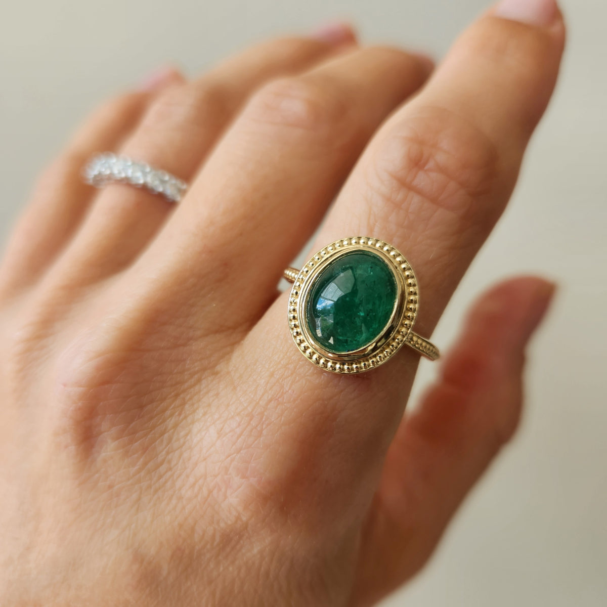 14 Karat Yellow Gold Bezel Set Oval Cabochon Emerald Ring With Milgrain Detail