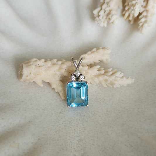 14 Karat White Gold Emerald Cut Blue Topaz & Diamond Pendant
