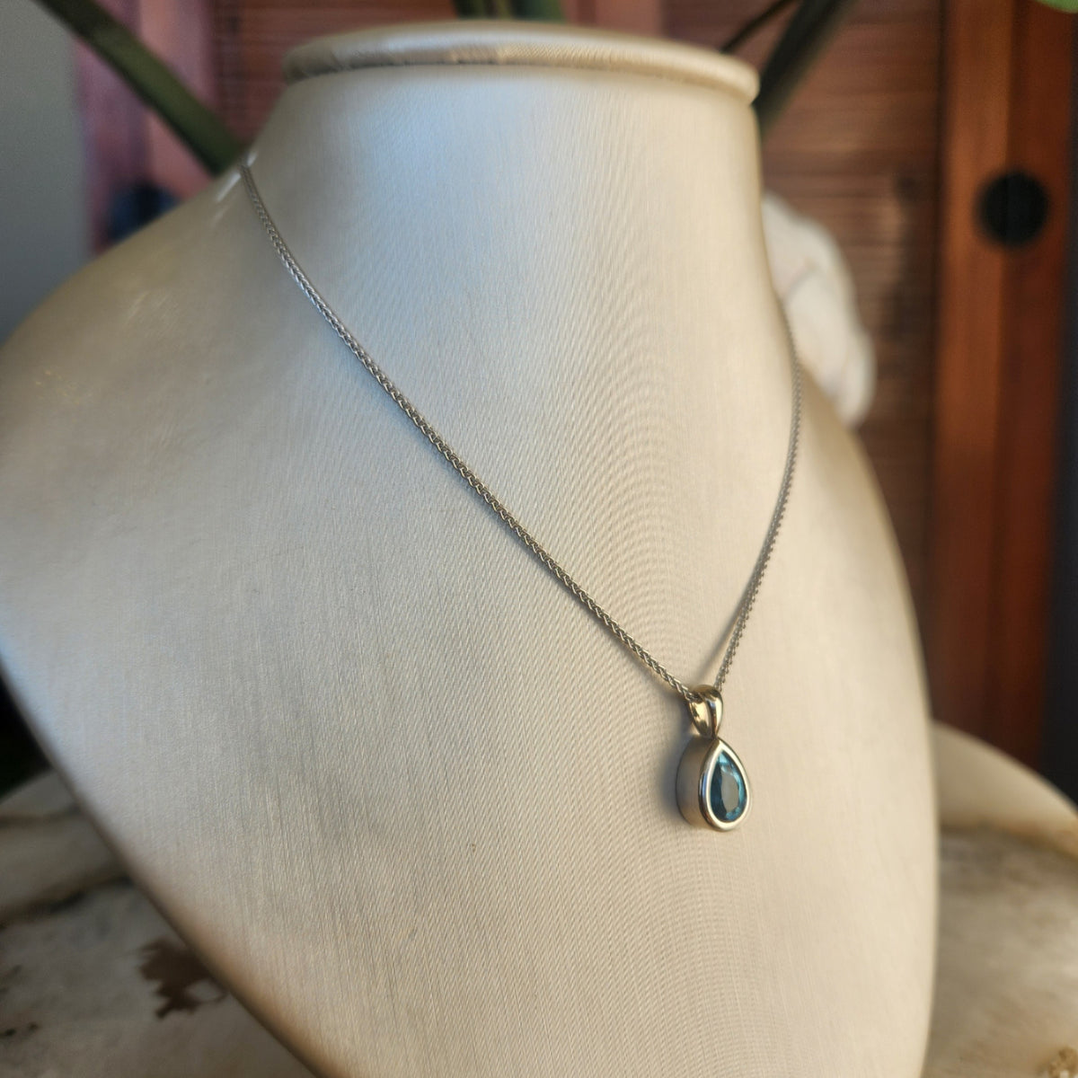 14 Karat White Gold Bezel Set Pear Blue Topaz Solitaire Pendant