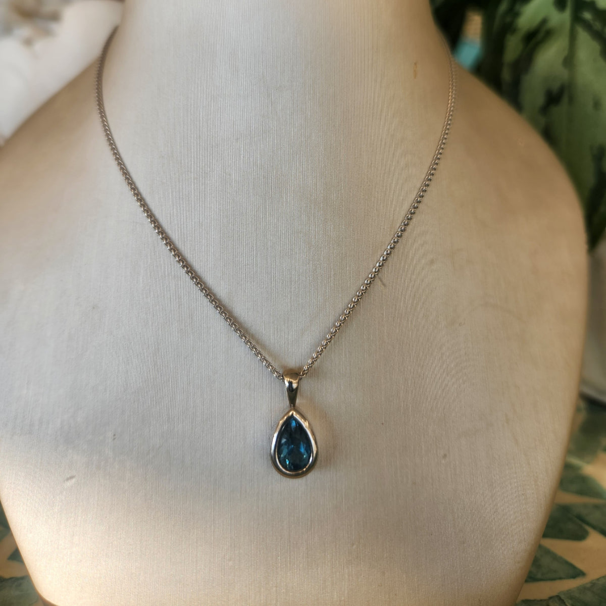 14 Karat White Gold Bezel Set Pear Blue Topaz Solitaire Pendant