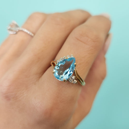 Vintage 14 Karat Yellow Gold Pear Shaped Blue Topaz Bypass Style Ring With Diamond Accents