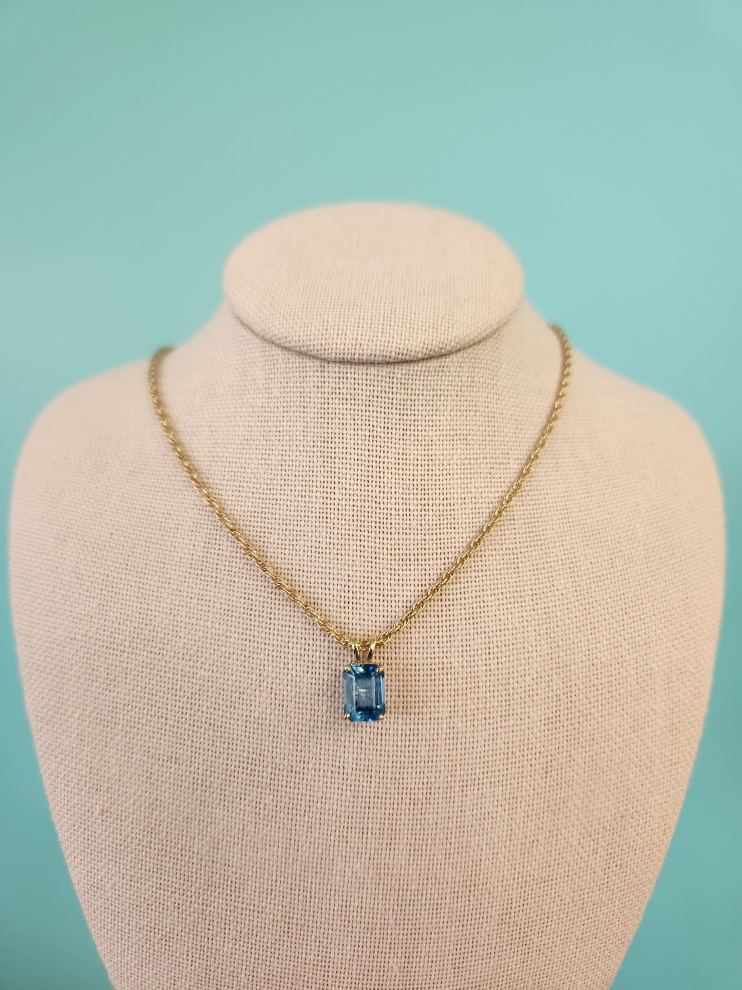 14 Karat Yellow Gold Emerald Cut Blue Topaz Solitaire Pendant