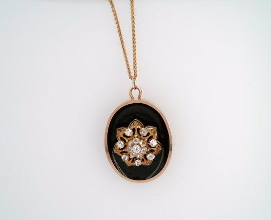 Antique Victorian Era 14 Karat Yellow Gold Oval Pendant/Pin With Black Onyx & Old Mine Cut Diamond Floral Cluster In Center With Black Enamel Accents