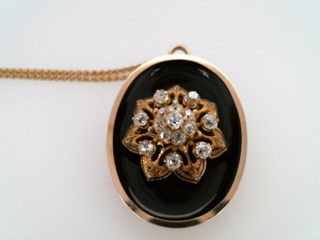 Antique Victorian Era 14 Karat Yellow Gold Oval Pendant/Pin With Black Onyx & Old Mine Cut Diamond Floral Cluster In Center With Black Enamel Accents