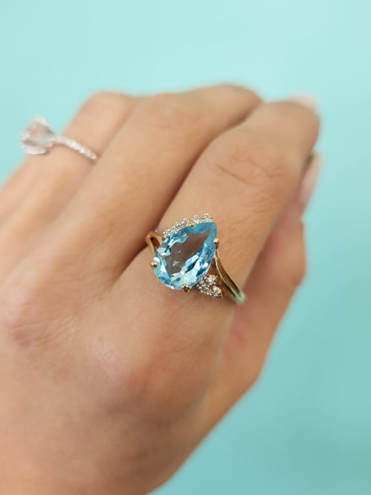 Vintage 14 Karat Yellow Gold Pear Shaped Blue Topaz Bypass Style Ring With Diamond Accents