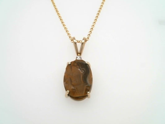 14 Karat Yellow Gold Oval Carved Tiger's Eye Inaglio Pendant With Diamond Accent